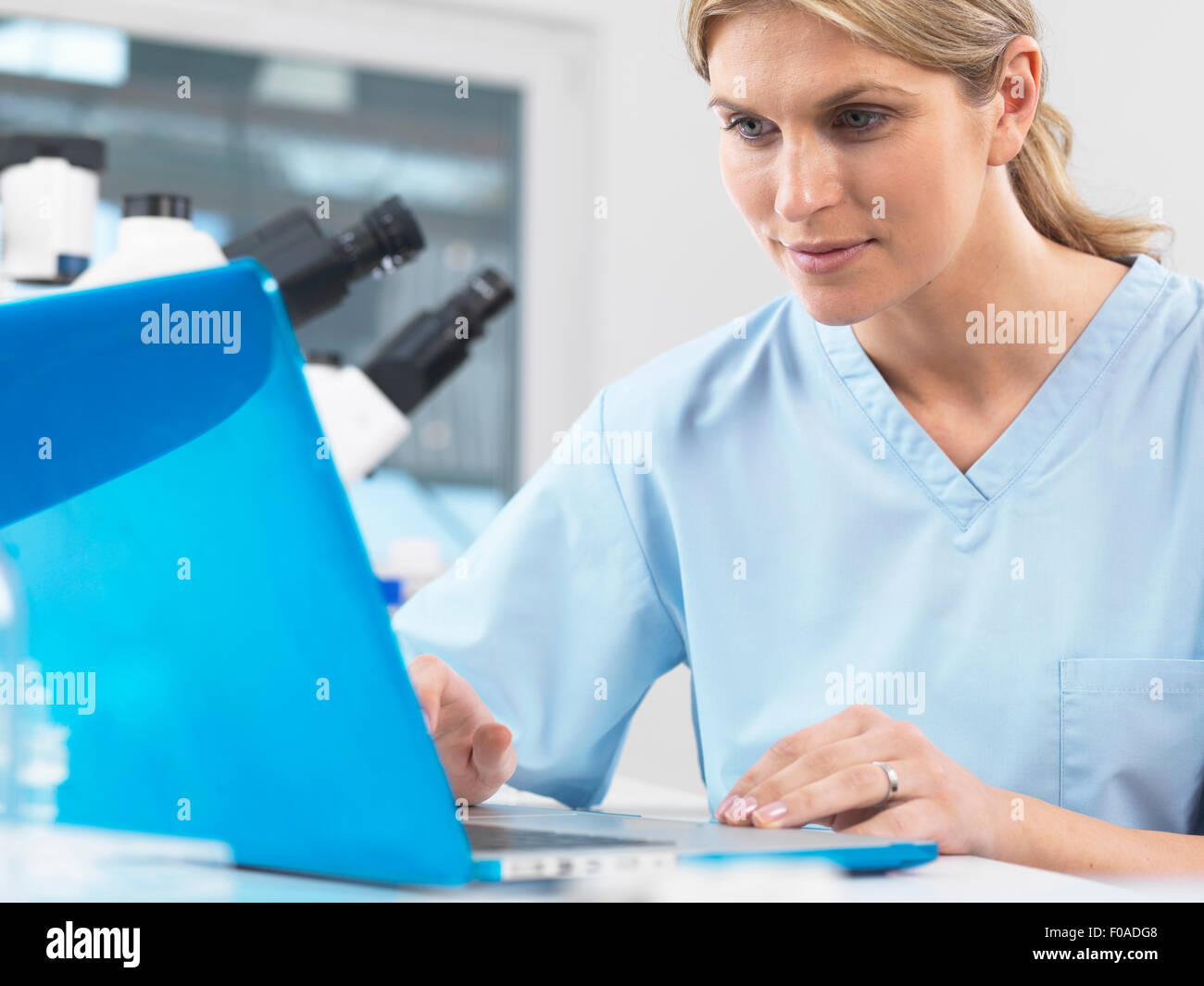Medical scientist viewing patients test results on a computer Stock Photo