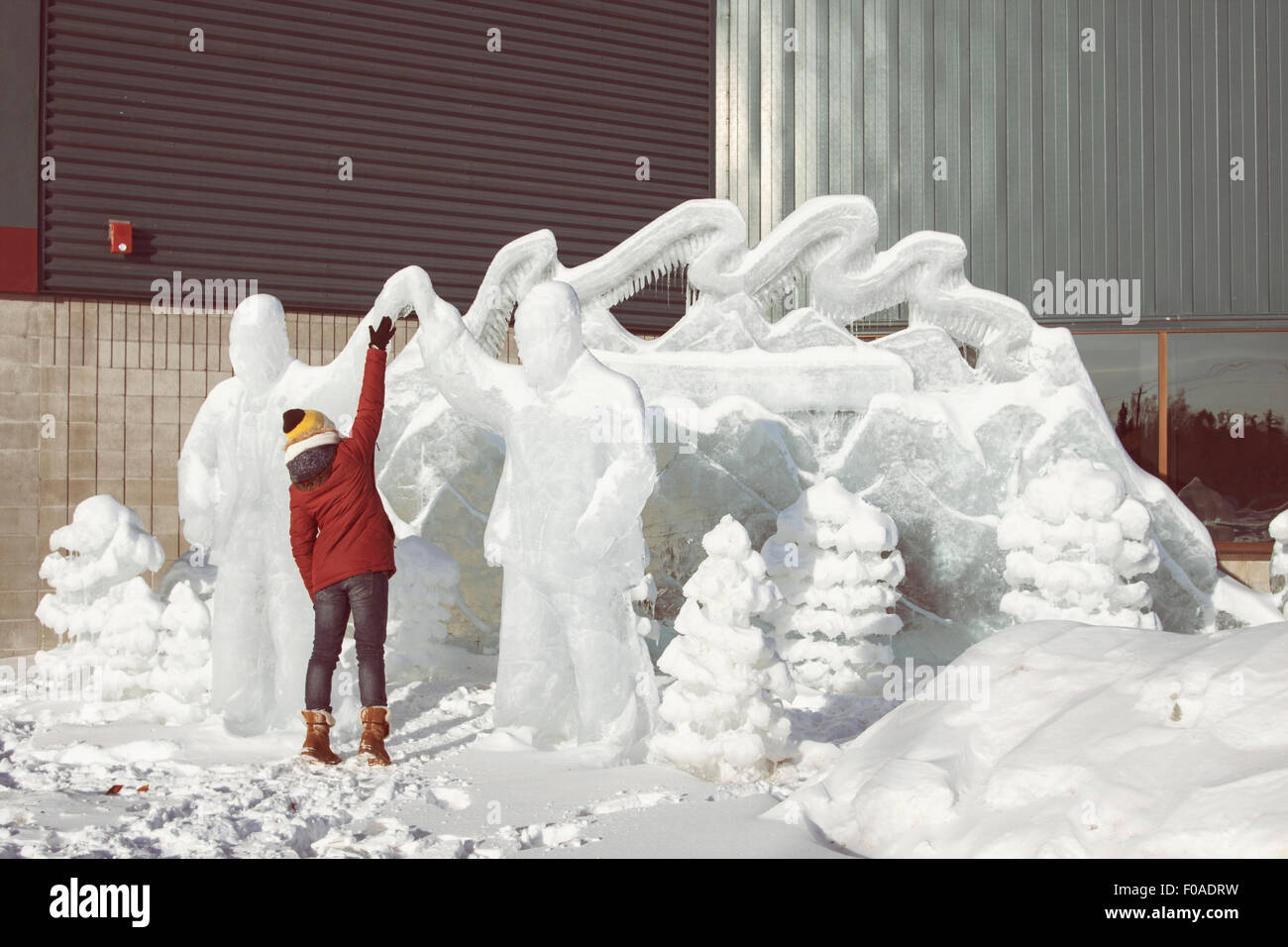 Woman touching ice sculpture Stock Photo