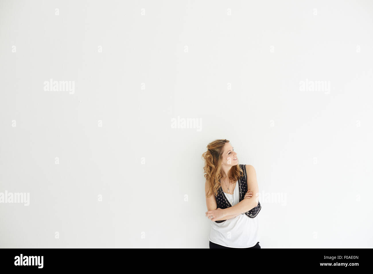 Mid adult woman arms crossed looking away Stock Photo