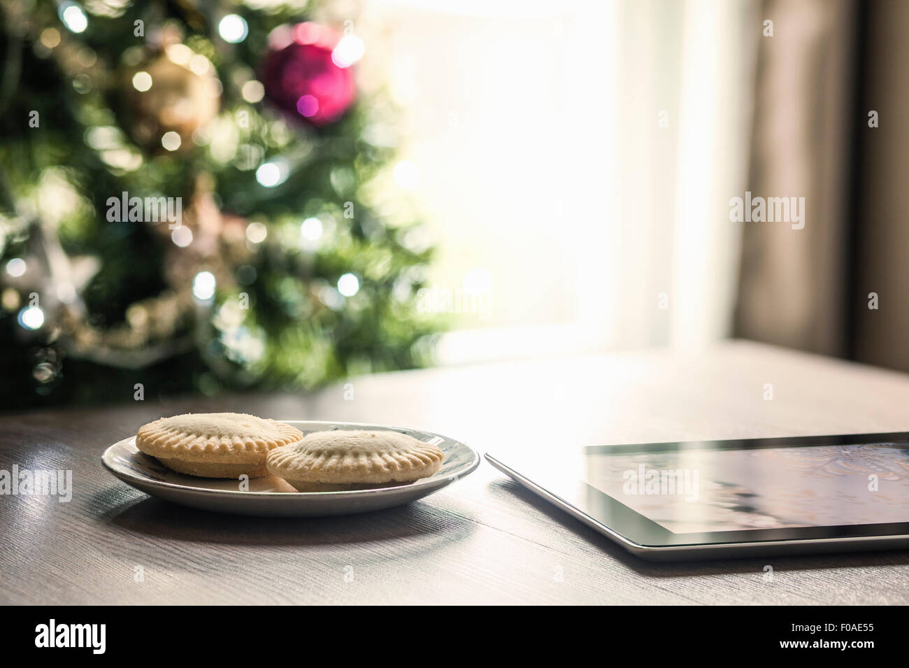 Mince pies and digital tablet on table Stock Photo