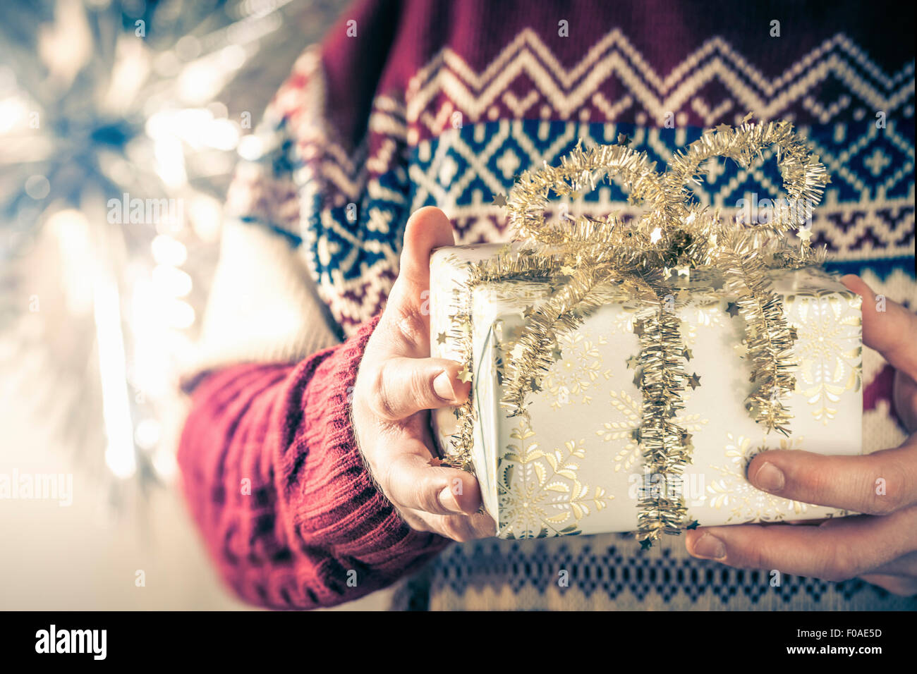 Person holding christmas gift Stock Photo