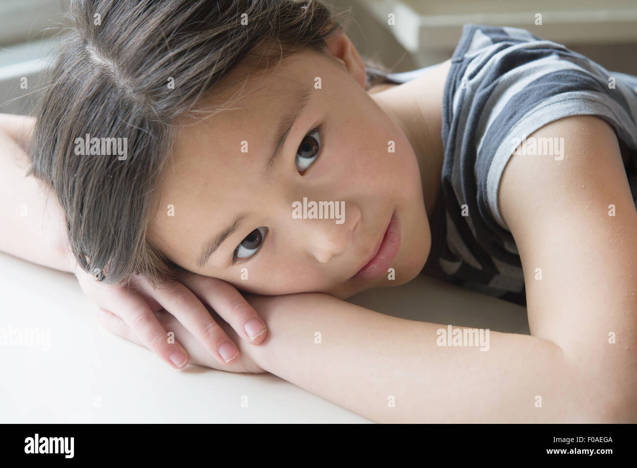 Portrait of cute girl resting on hands Stock Photo