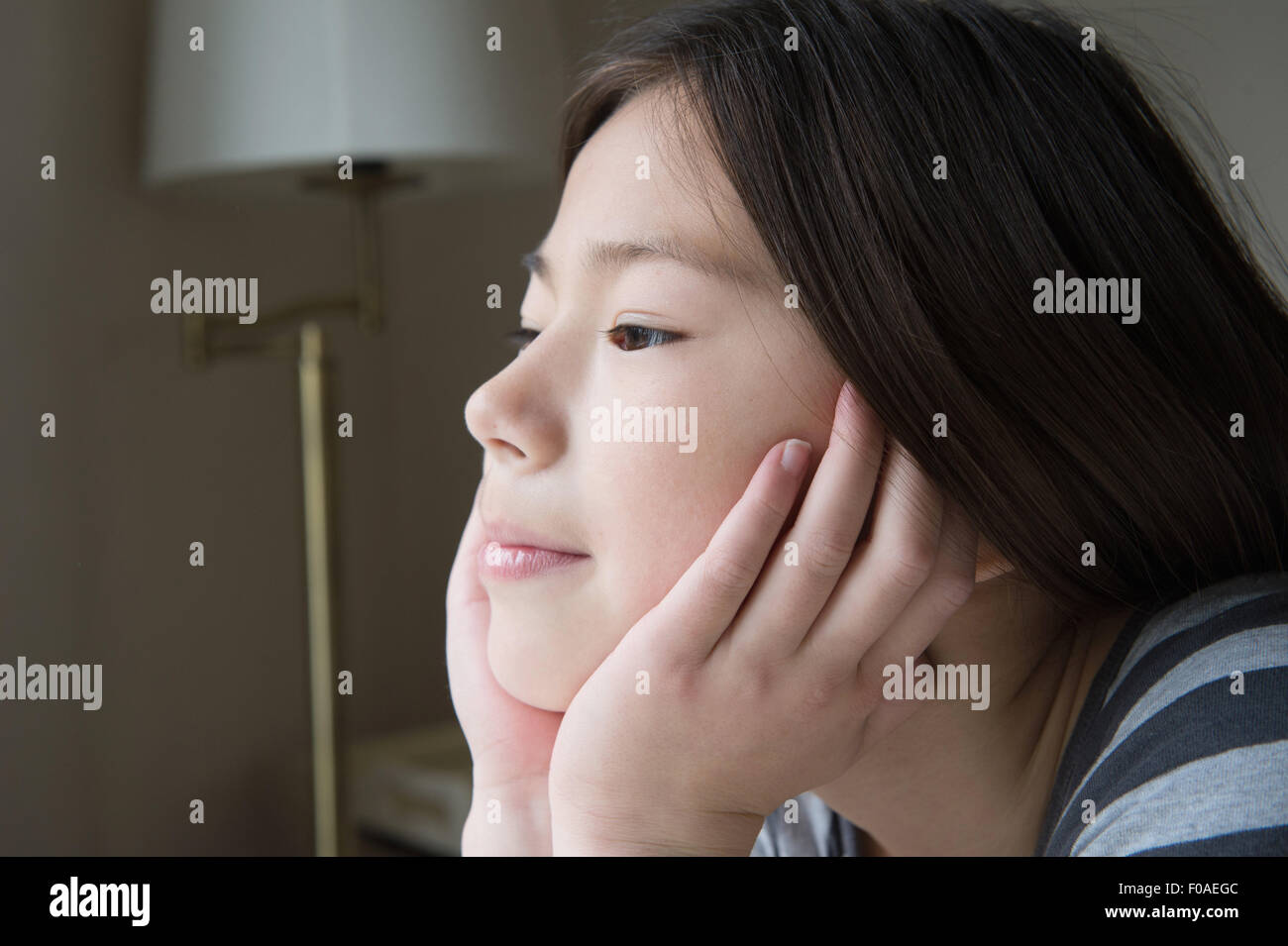 Portrait of cute girl with chin on hands Stock Photo