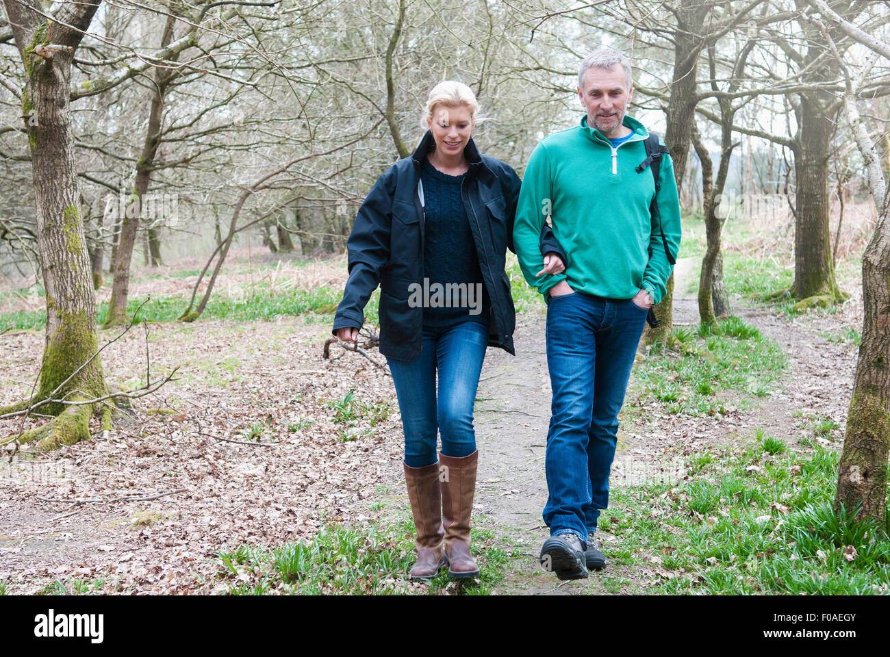 Hiking couple walking in woods Stock Photo