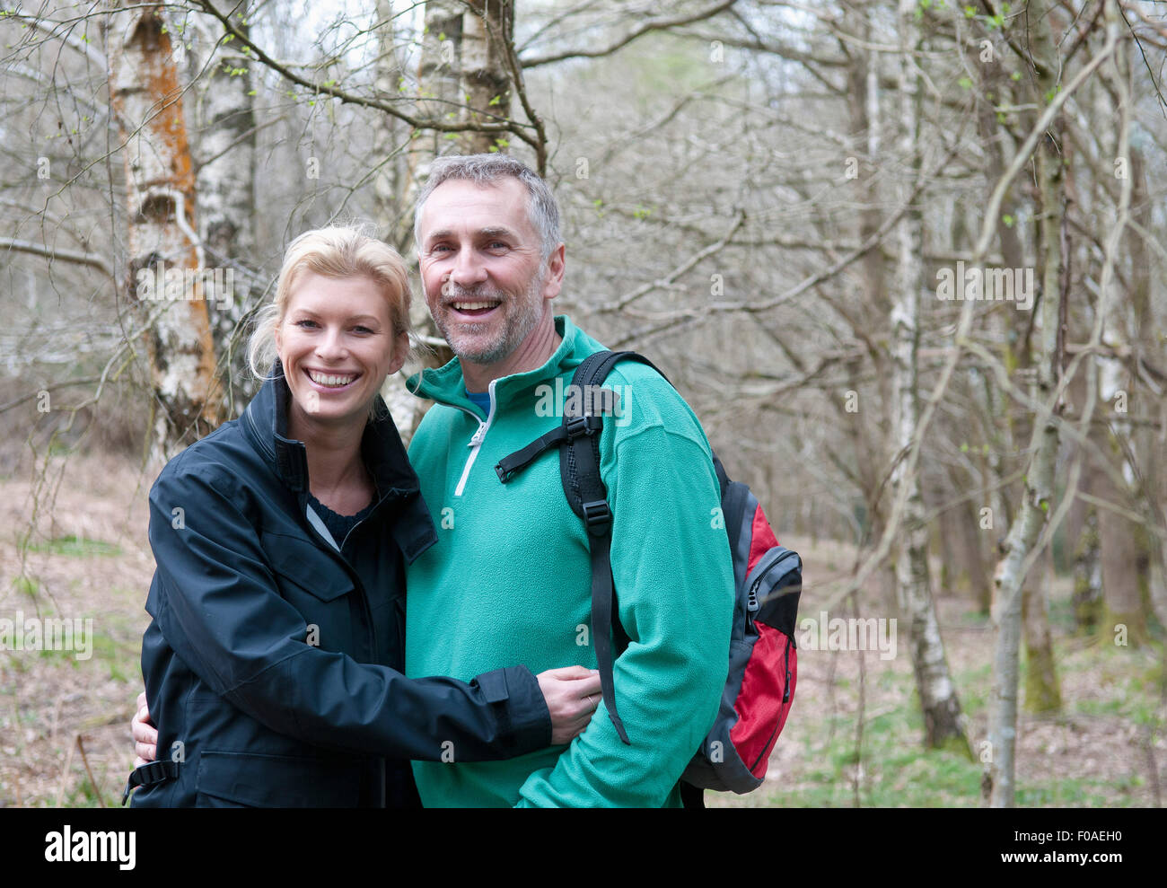 Portrait of hiking couple walking in woods Stock Photo