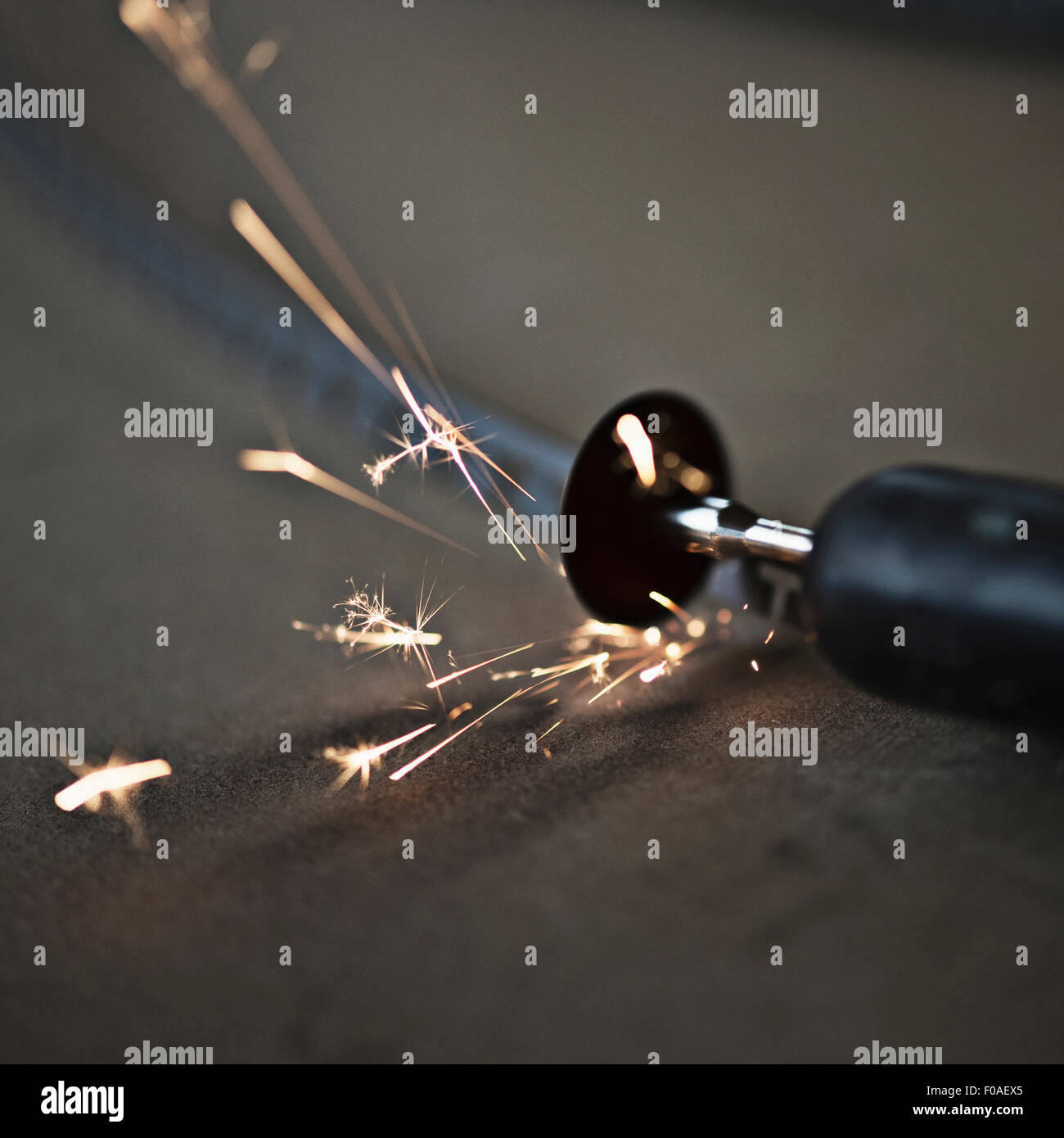 Small disc cutter creating sparks, close-up Stock Photo
