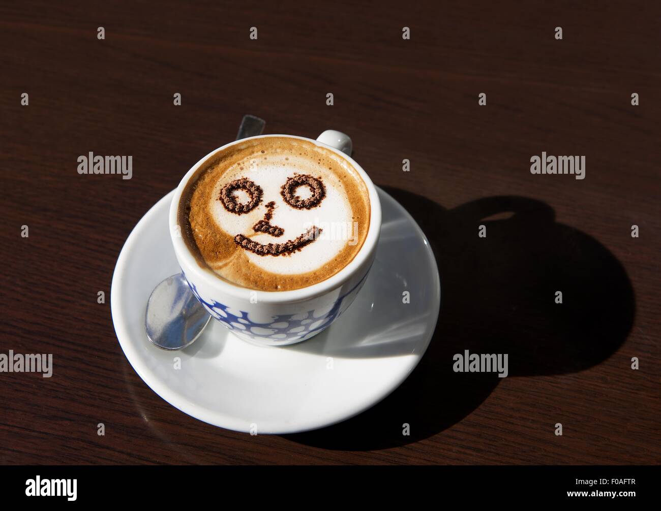 A cup of cappucino coffee, delicious morning drink, cup of morning coffee, Cup with coffee lather in blurry background, morning Stock Photo