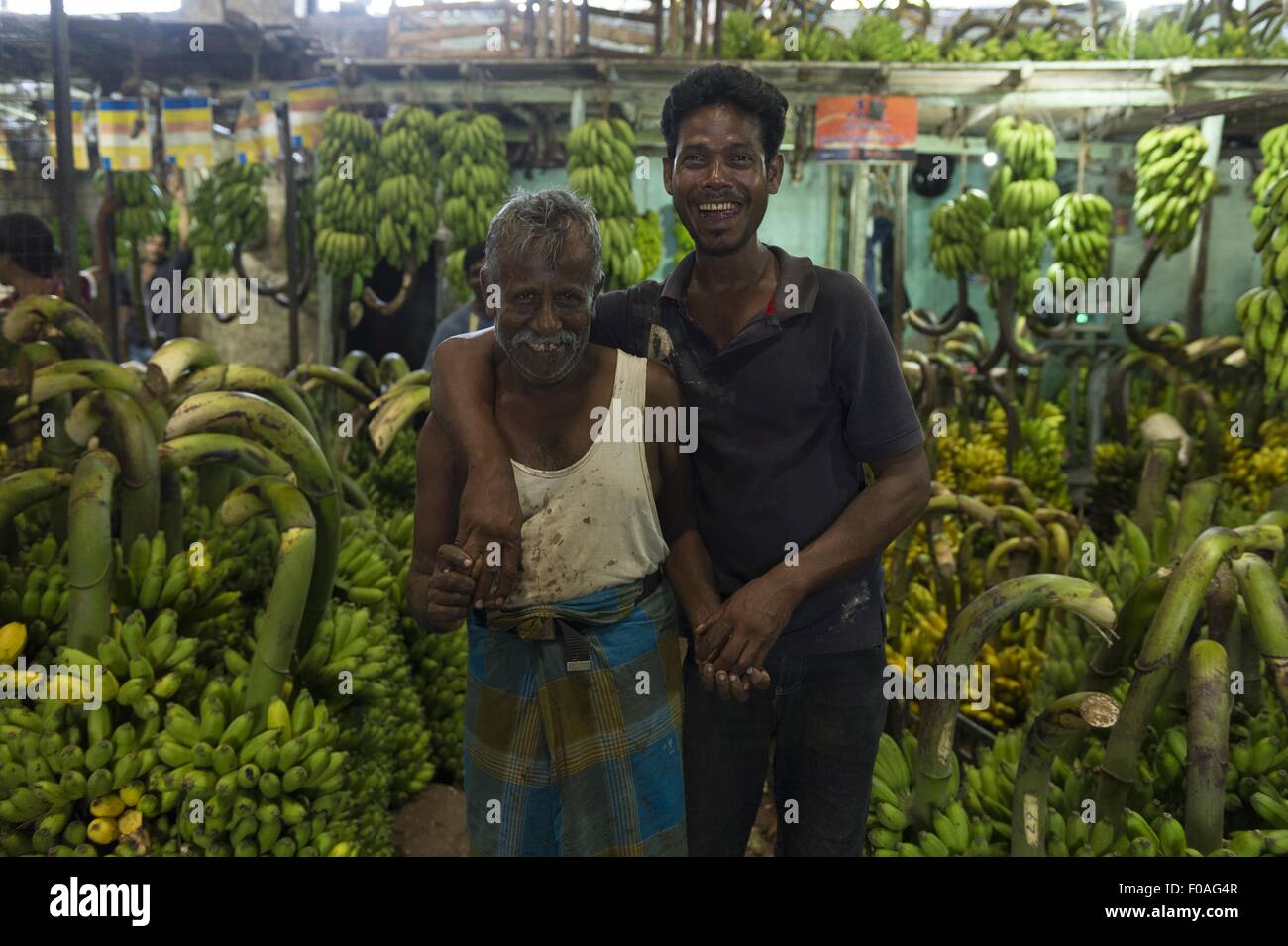 Two banana vendors standing in shop at Colombo, Sri Lanka Stock Photo