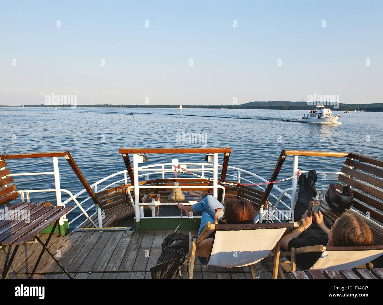 People relaxing on dock of ship in Muggelsee, Berlin, Germany Stock ...