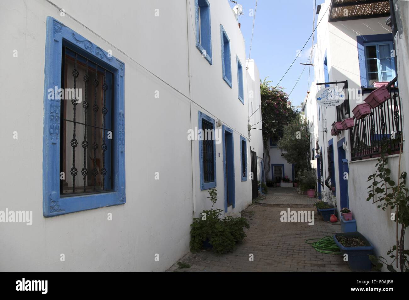 View of alley between blue and white buildings in Bodrum Peninsula, Aegean, Turkey Stock Photo