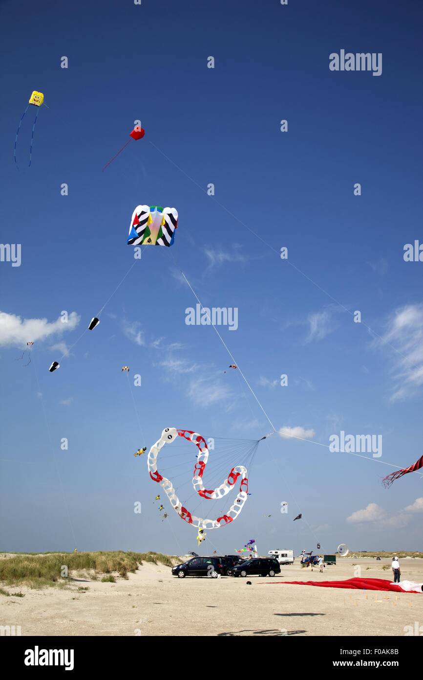 Multicoloured flags in sky on kite festival at Fano beach, Denmark