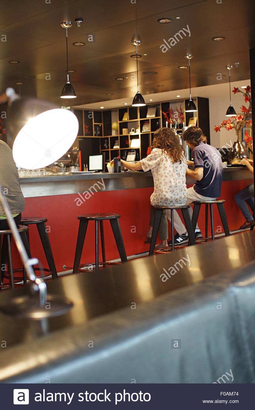 Sitting On Bar Stool Stock Photos & Sitting On Bar Stool Stock Images