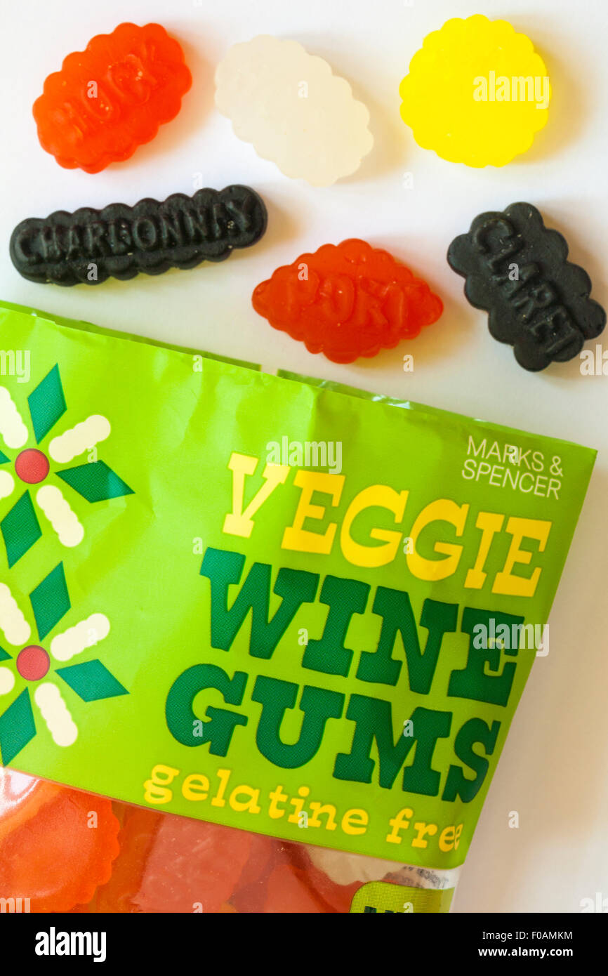 pack of Marks & Spencer veggie wine gums gelatine free sweets with contents spilled showing wine names set on white background Stock Photo