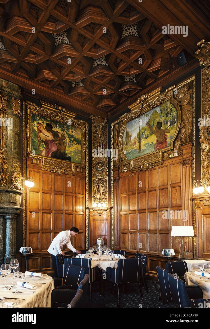 A waiter arranging table inside Operakallaren Restaurant, Stockholm