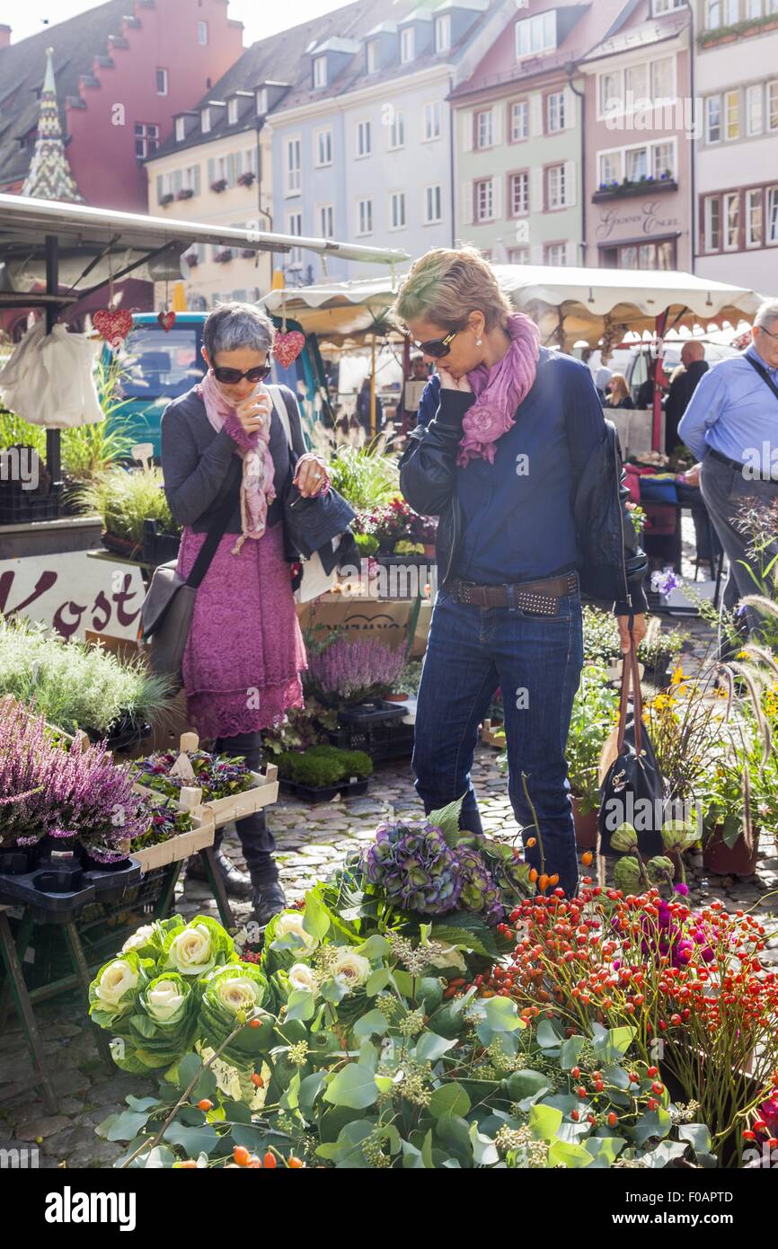 People in flower market on Cathedral square in Freiburg, Germany Stock