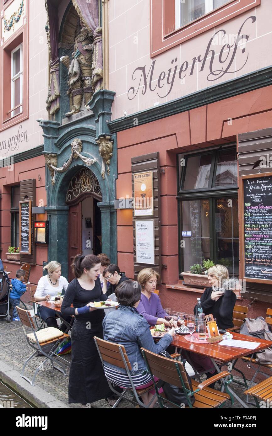 People sitting outside tavern Big Meyerhof in Old Town Freiburg, Germany Stock Photo