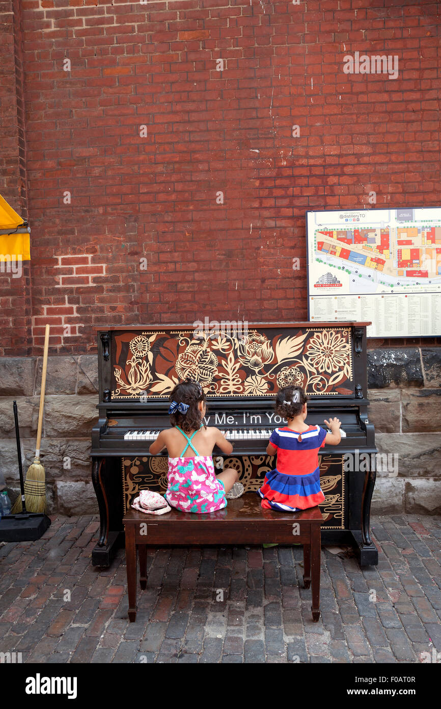 2 Girls 4 6 Years Old Are Playing The Piano Outdoors At The Stock