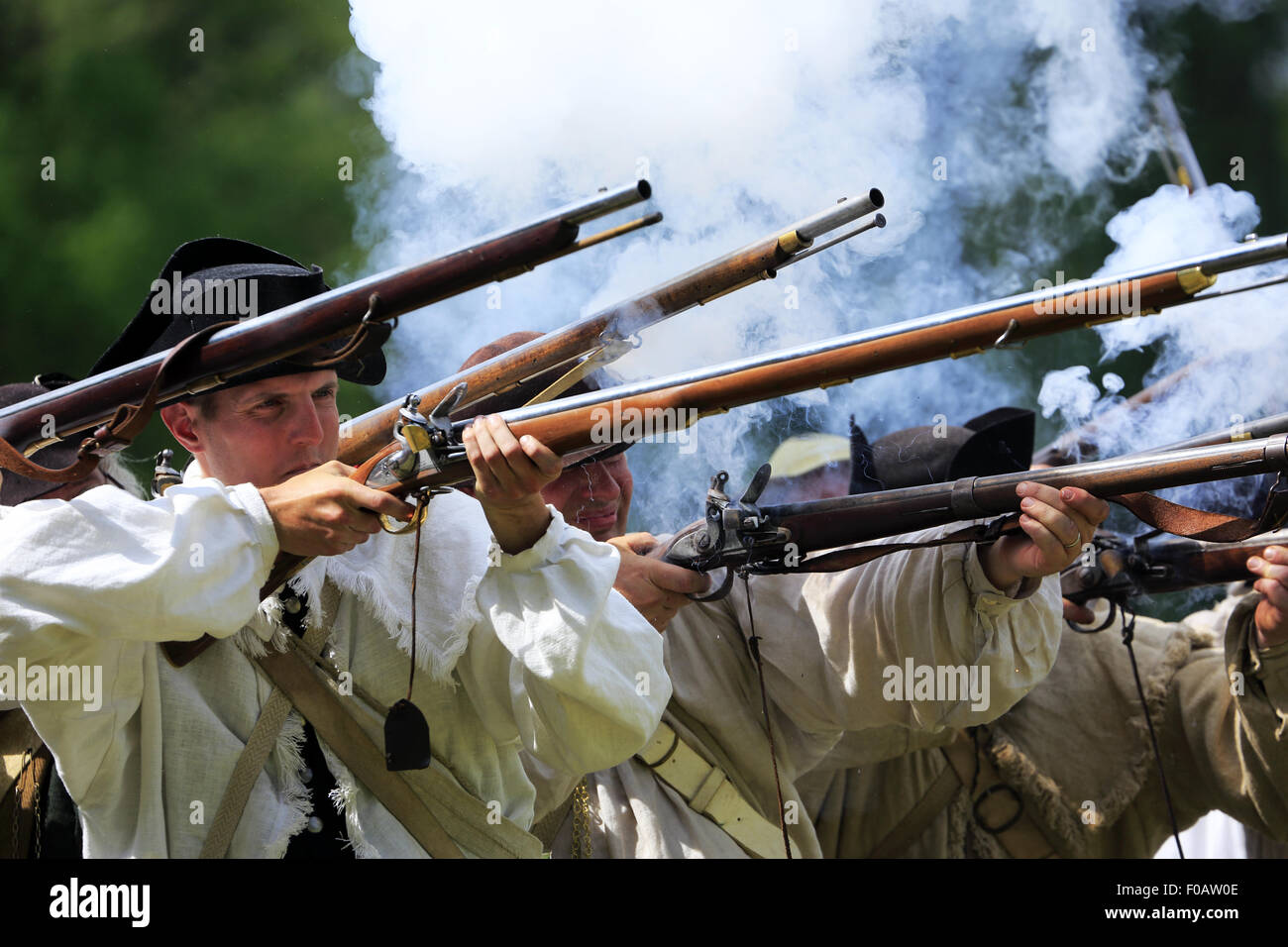 Continental Army soldiers firing muskets during Revolutionary War reenactment at Jockey Hollow in Morristown National Historical Park,New Jersey, USA Stock Photo