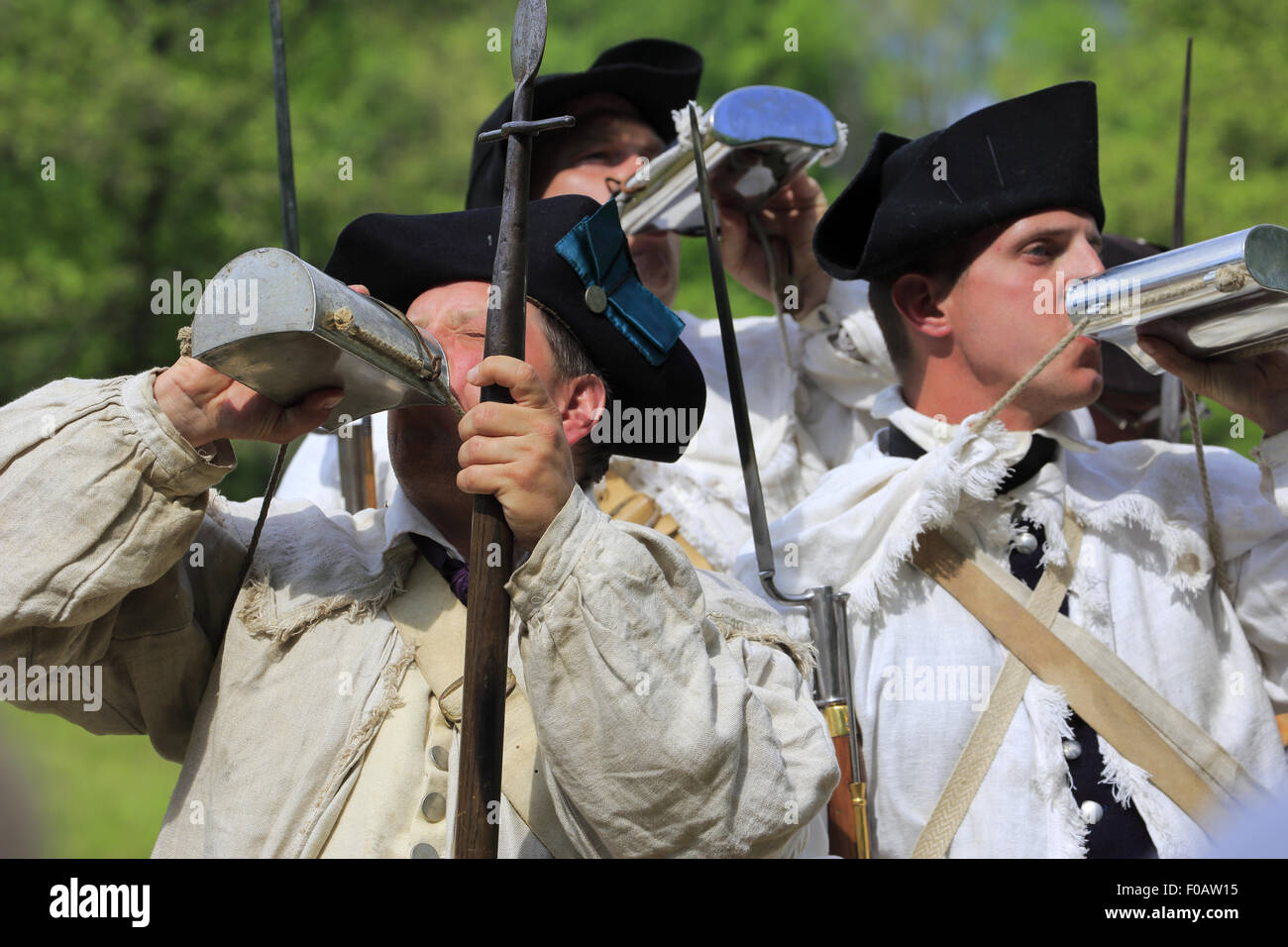 Soldiers of Continental Army drinking from flask in Revolutionary War reenactment in Jockey Hollow,Morristown National Historical Park NJ USA Stock Photo