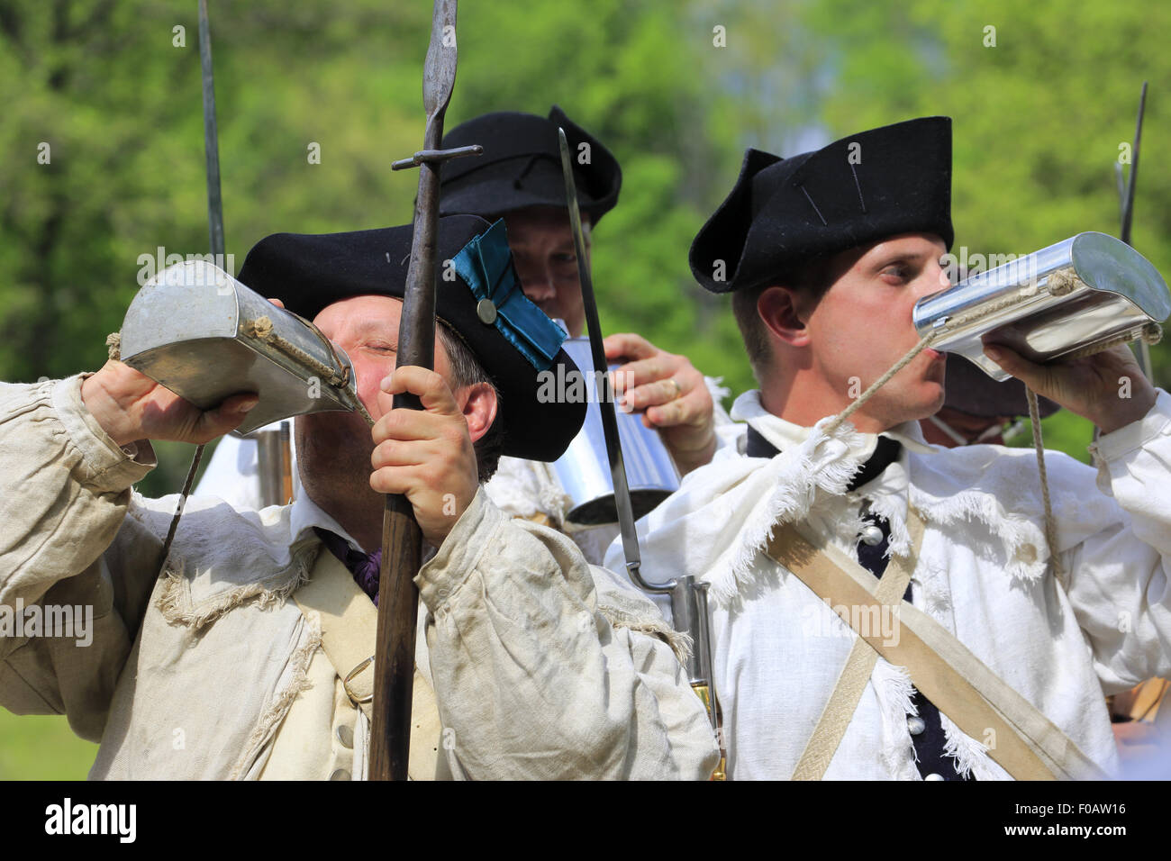 Soldiers of Continental Army drinking from flask in Revolutionary War reenactment in Jockey Hollow,Morristown National Historical Park NJ USA Stock Photo