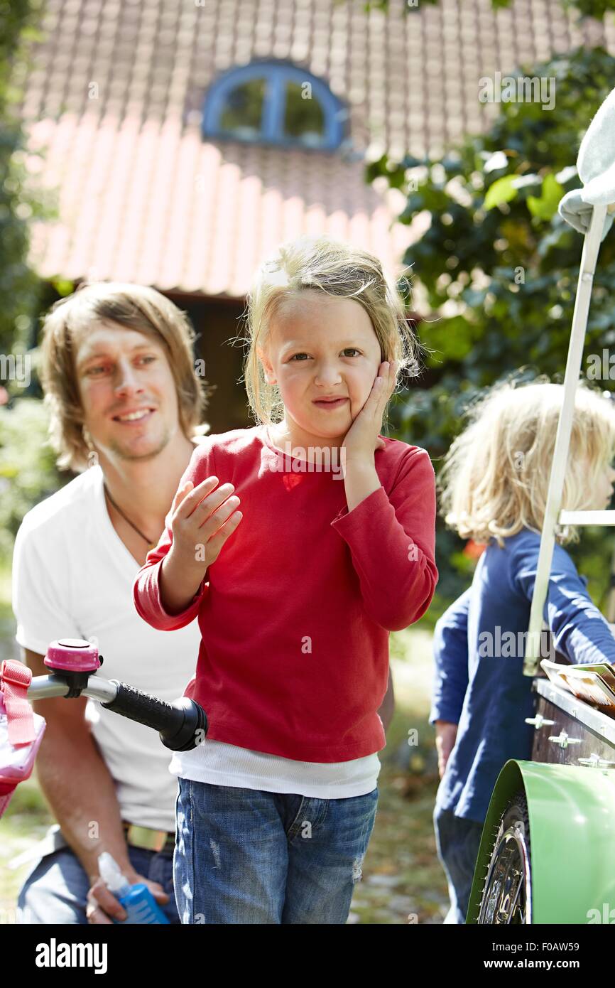 Child applying lotion on face Stock Photo Alamy