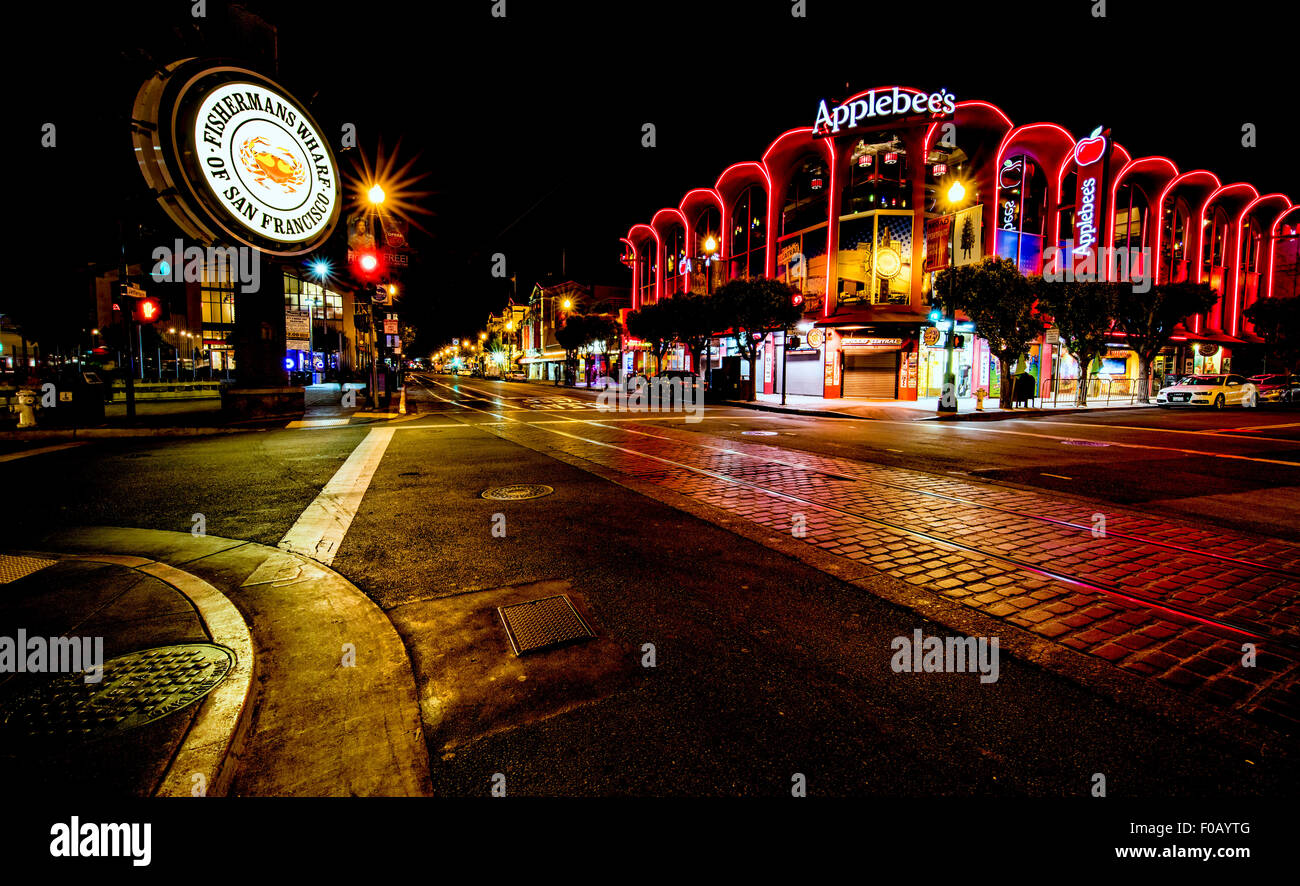 San Francisco, CA, USA - June 25th, 2015: Famous Fisherman's Wharf street and signage at night and Applebee's restaurant. Stock Photo
