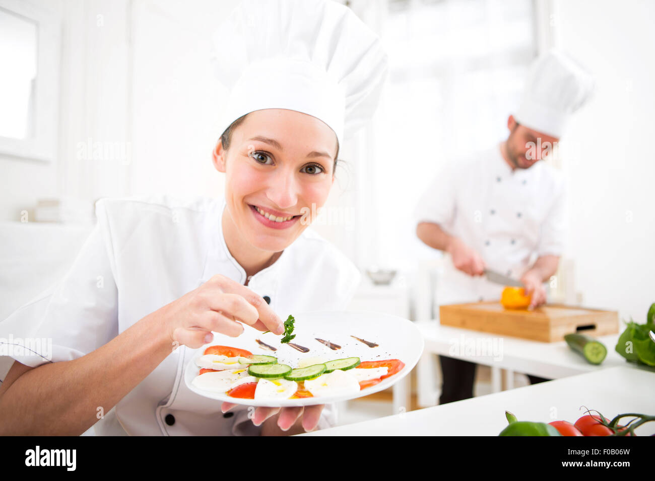 View of a Young attractive professional chef cooking in his kitchen Stock Photo