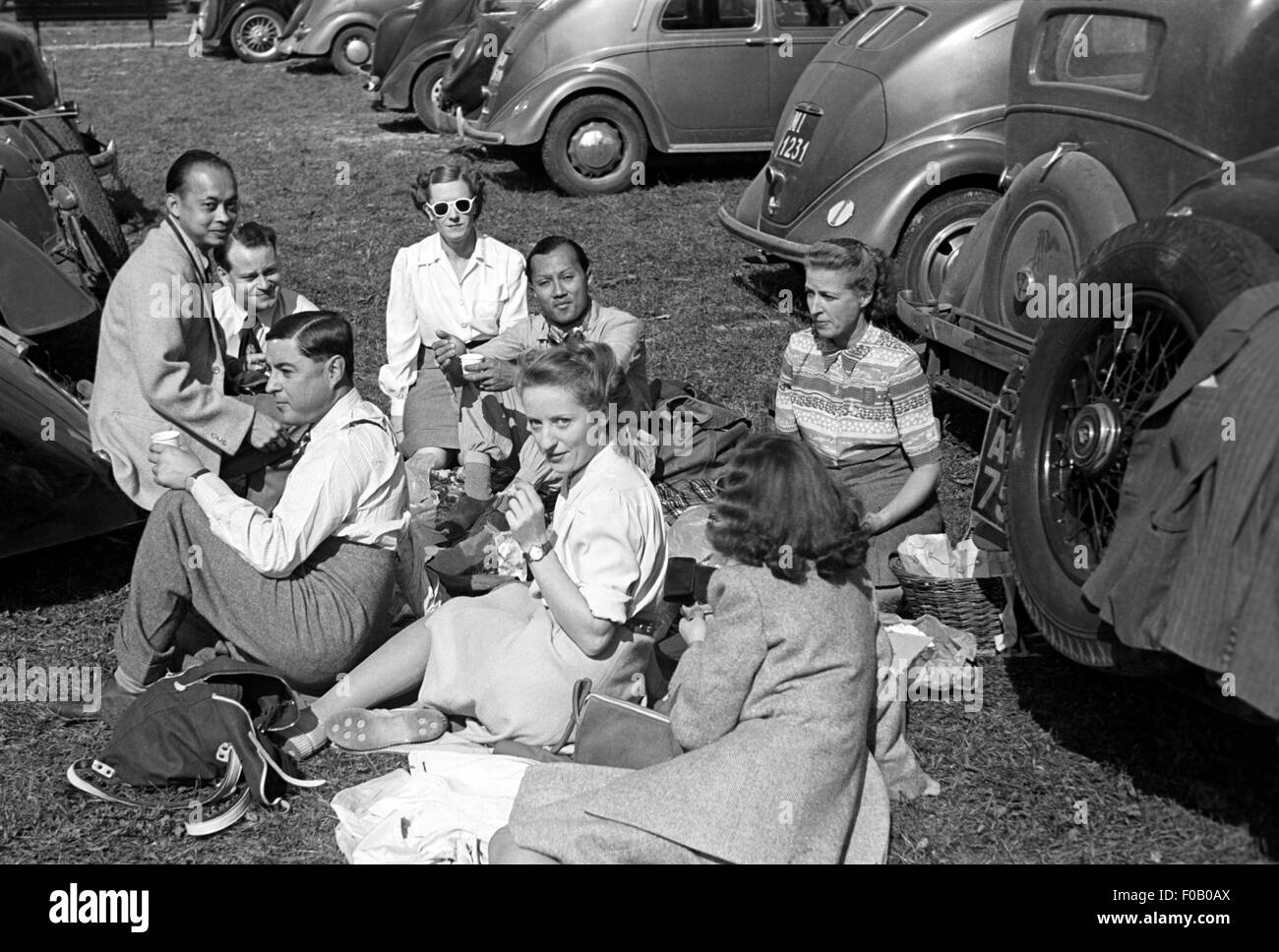 Prince Bira with group of people at a picnic in a car park Stock Photo