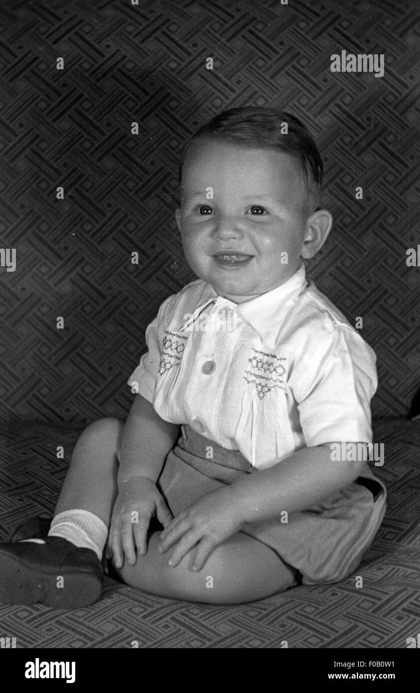 A young boy sitting on a sofa Stock Photo - Alamy