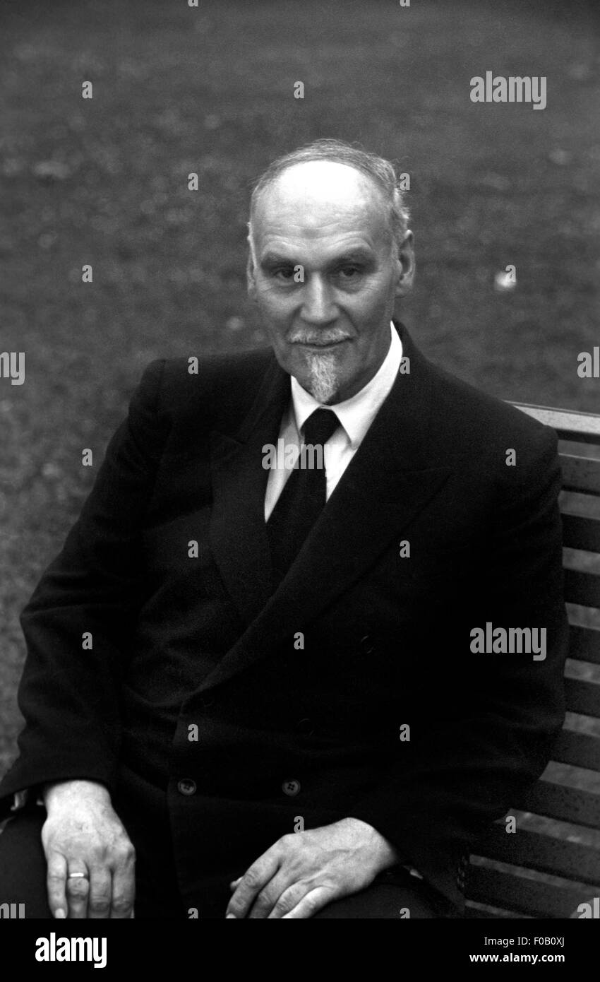 Portrait of a man sitting on a garden bench Stock Photo - Alamy