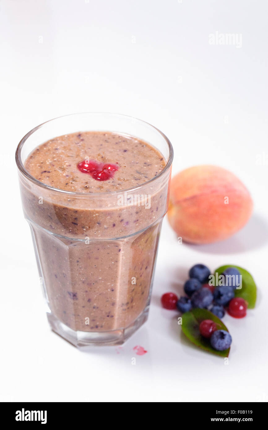 Peach, blueberry and redcurrant smoothie. Stock Photo