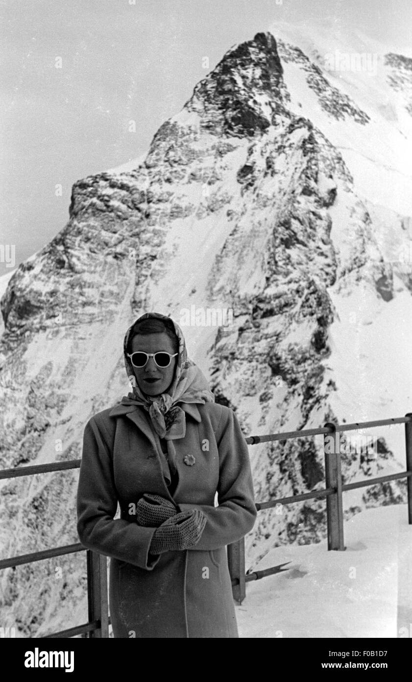 Portrait of a woman in front of a snow-capped mountain Stock Photo