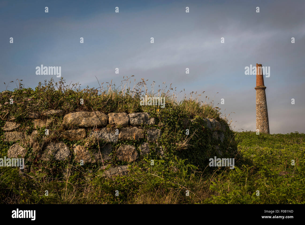 Old abandoned mine workings and chimney at Carn Gluze, Penwith, Cornwall, UK Stock Photo