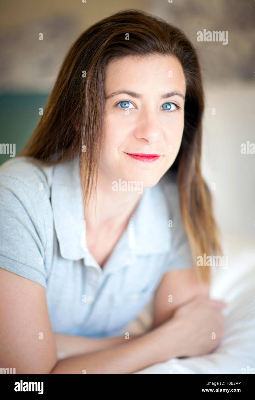 Pretty brunette woman lying on a bed Stock Photo