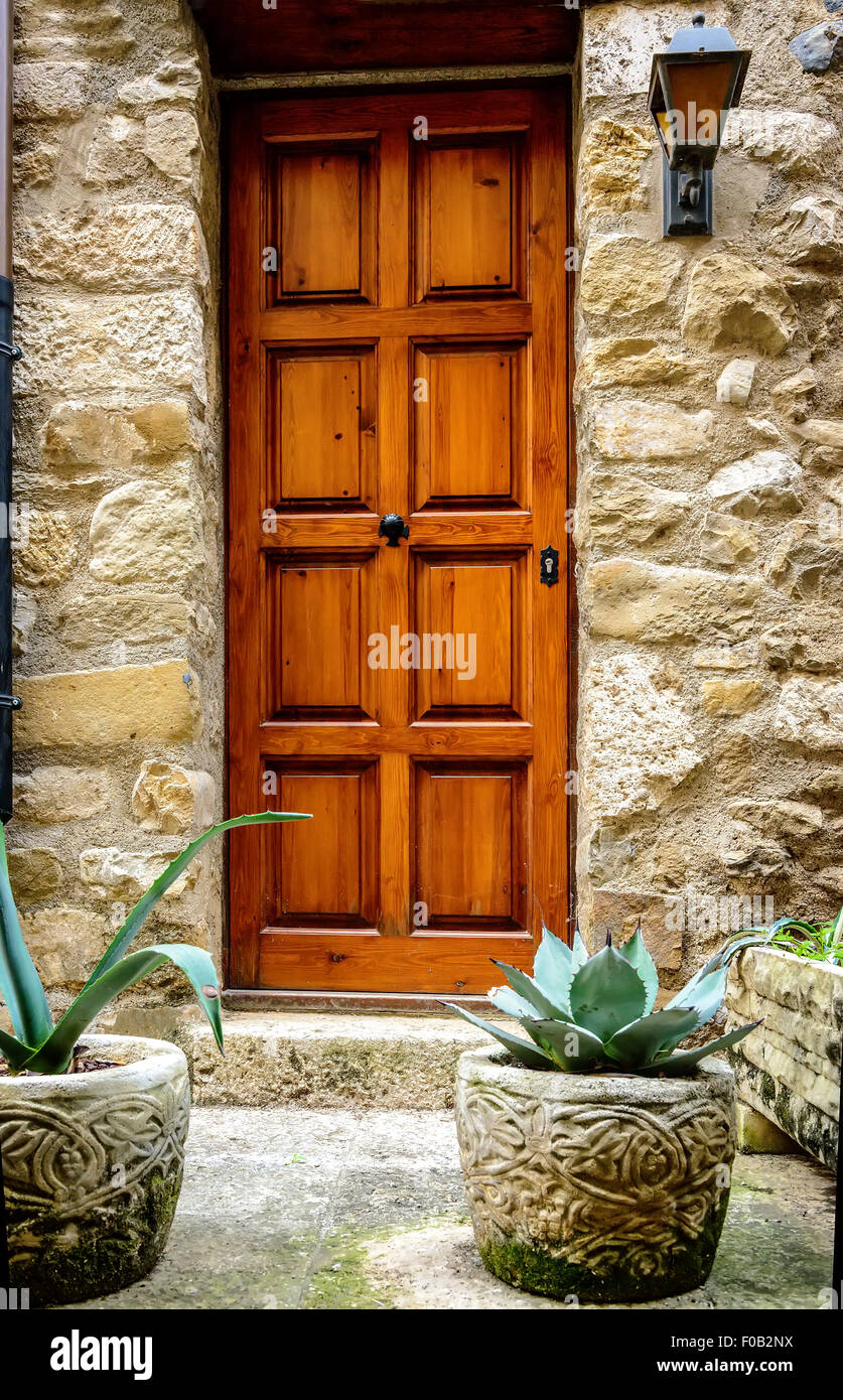 Wooden door in stone wall Stock Photo - Alamy