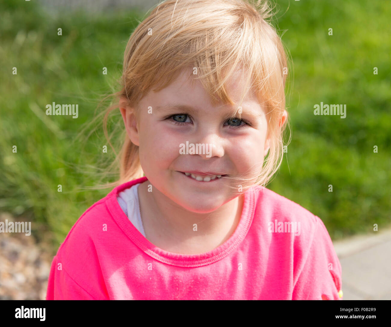 Portrait of 3 year old blonde girl, Daventry, Northamptonshire, England, United Kingdom Stock Photo