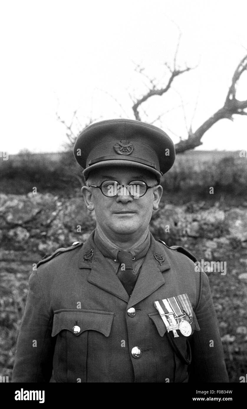 A man wearing glasses and his military uniform decorated with medals Stock Photo