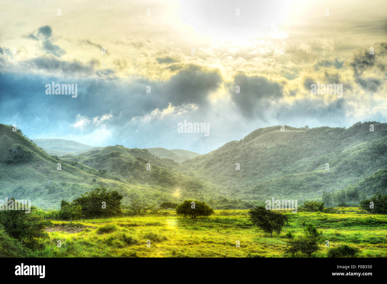 Beautiful morning colors shining down in a mountain range and valley down below in the countryside of Panama Stock Photo