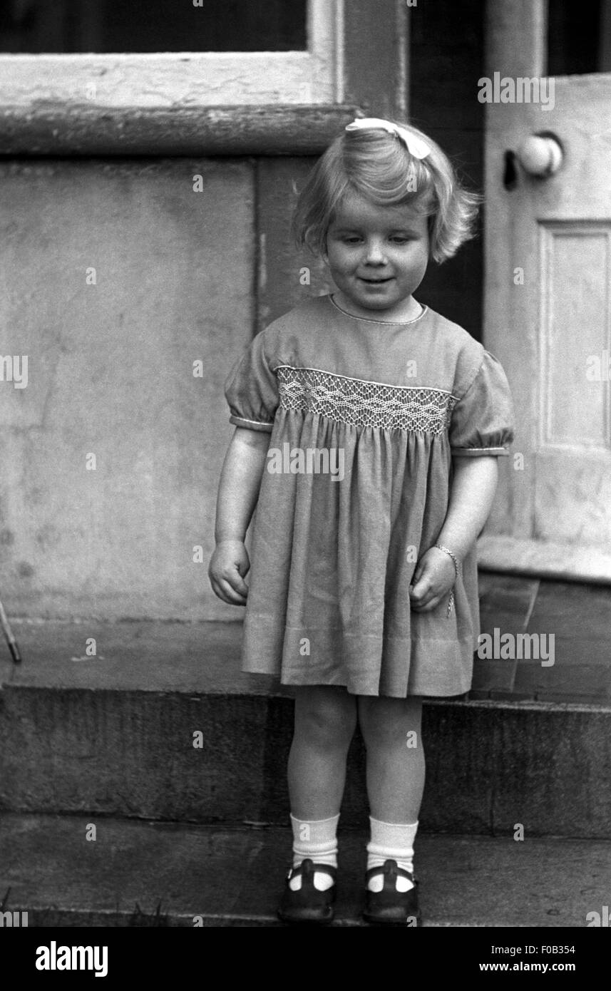 A little girl standing on the doorstep Stock Photo