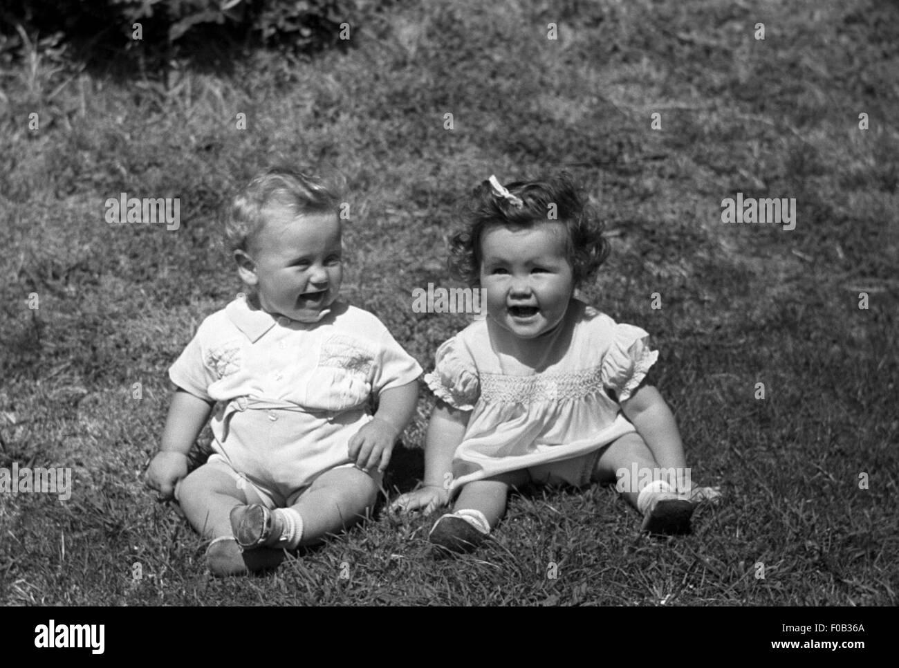 Two little children one boy and one girl smiling and  laughing Stock Photo