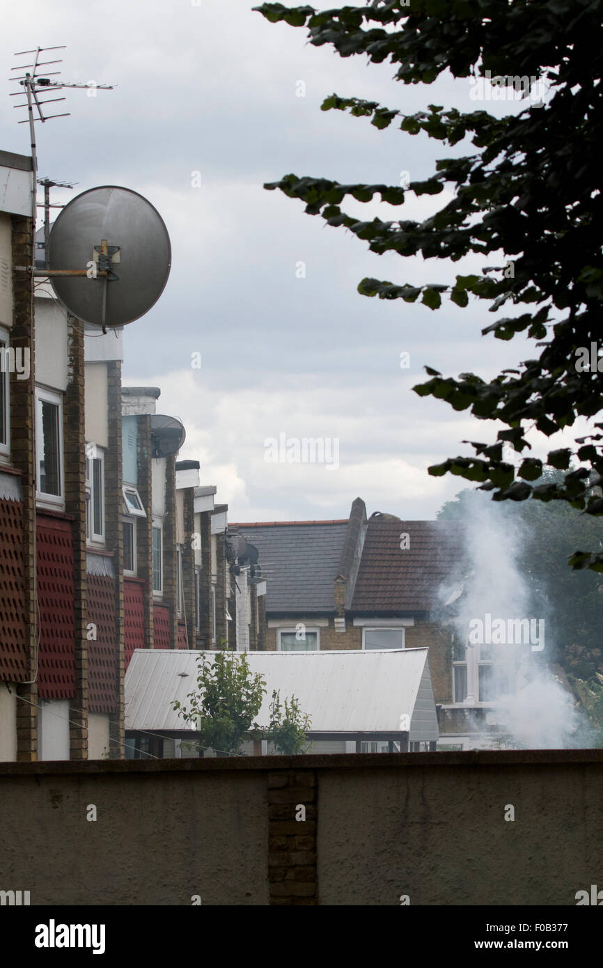 Smoke from neighbour's barbecue, antisocial behaviour in suburban garden Stock Photo