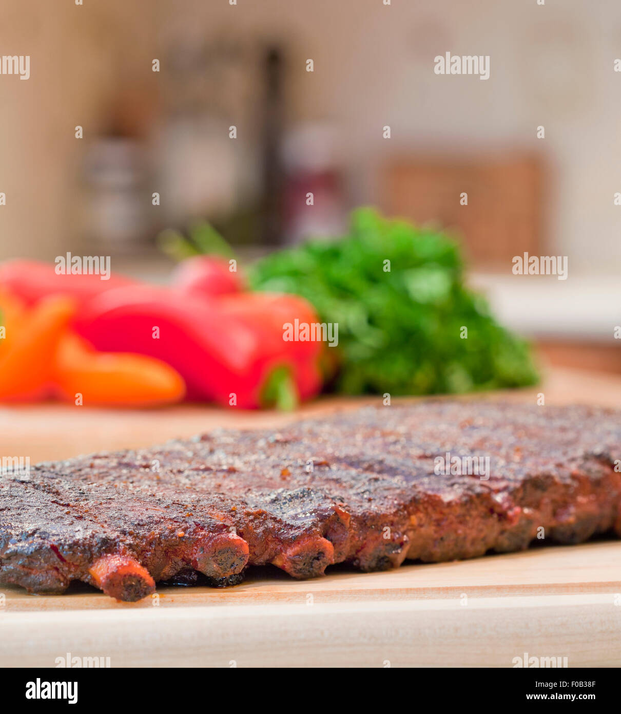 Fresh BBQ ribs on a wooden chopping board in studio Stock Photo