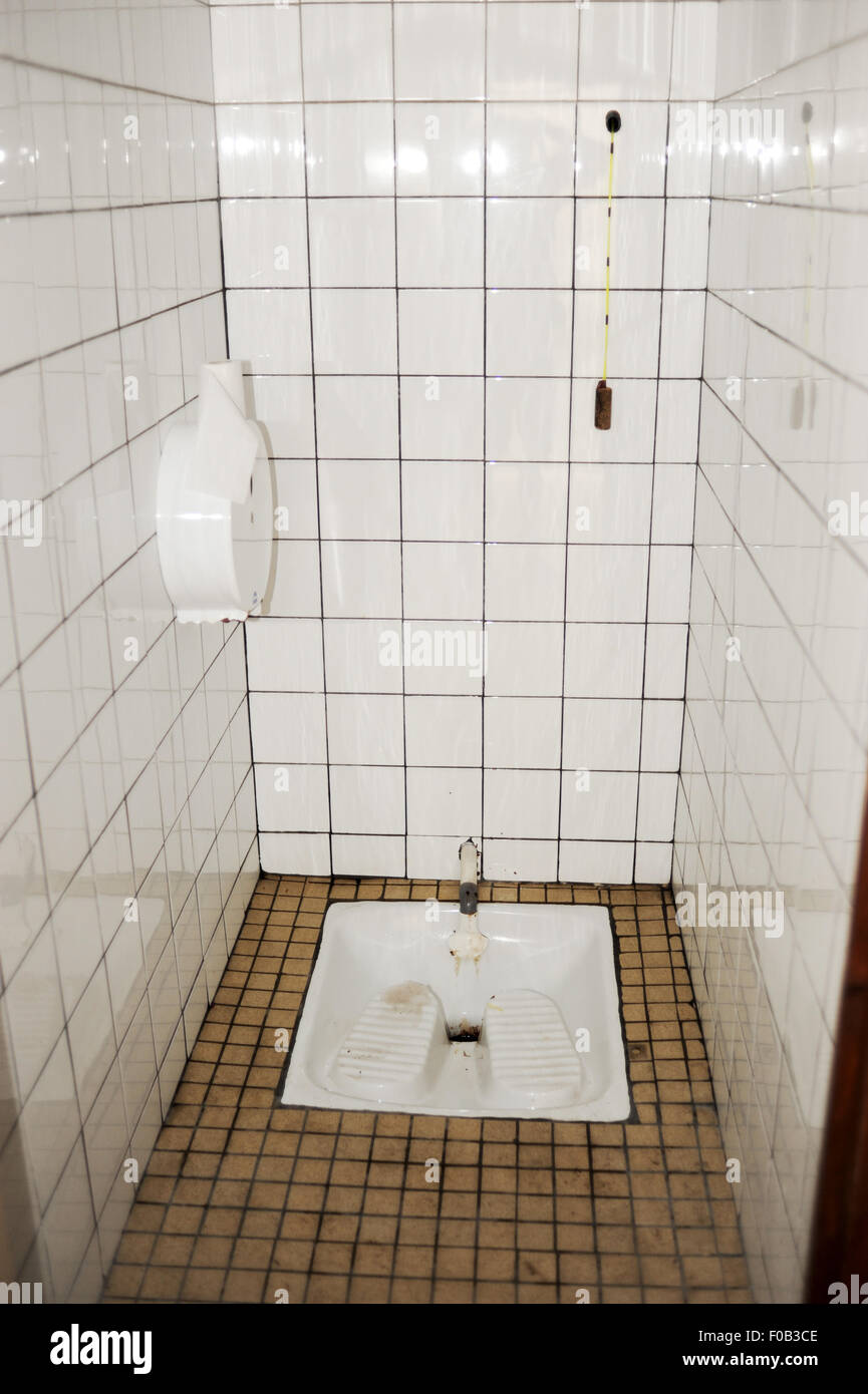 Old fashioned style public stand up above a hole public toilet in France Europe Stock Photo