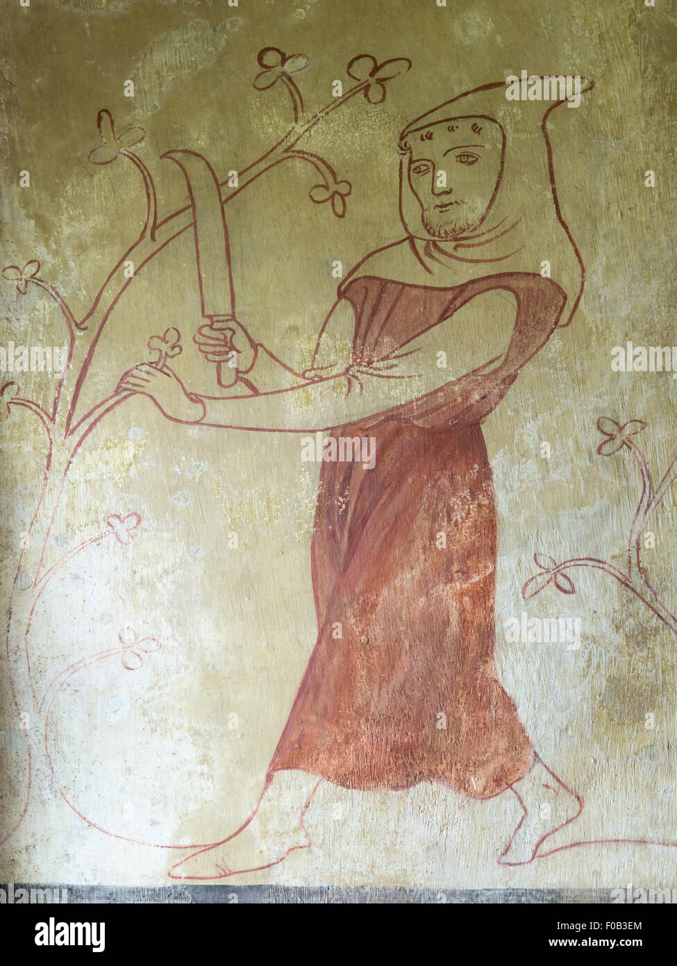 An agricultural labourer pruning a tree, as depicted in a medieval wall painting in Easby Church, Richmond, North Yorkshire, UK Stock Photo