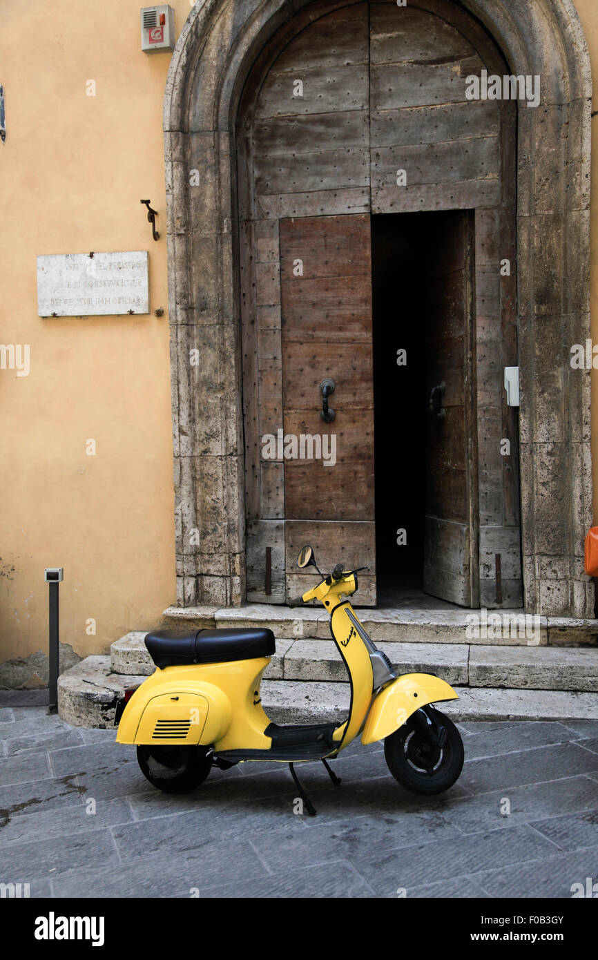 Yellow Vespa scooter. Photographed in Montepulciano, Tuscany, Italy Stock Photo