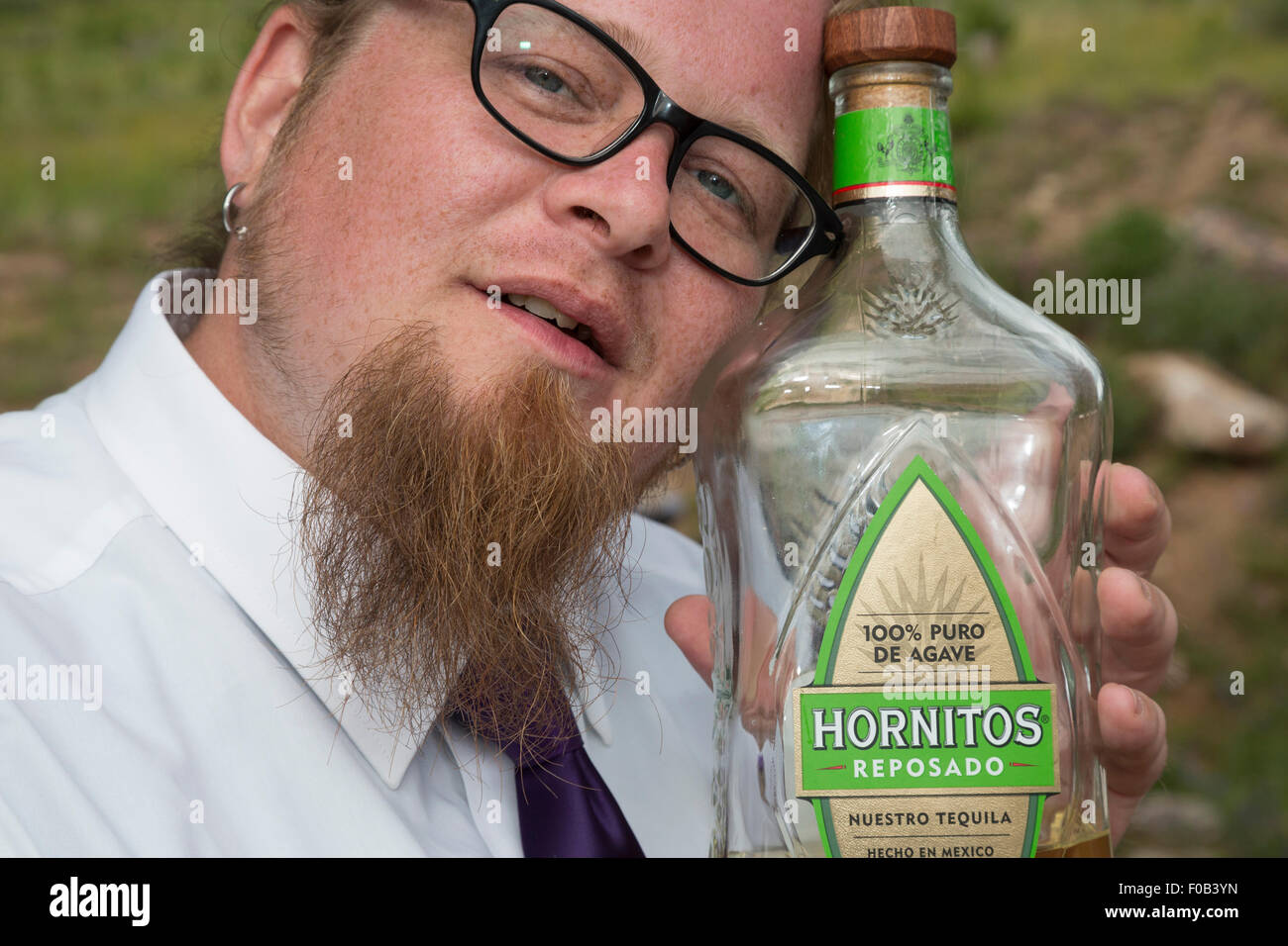 Dillon, Colorado - A man holds a tequila bottle during a wedding celebration. Stock Photo