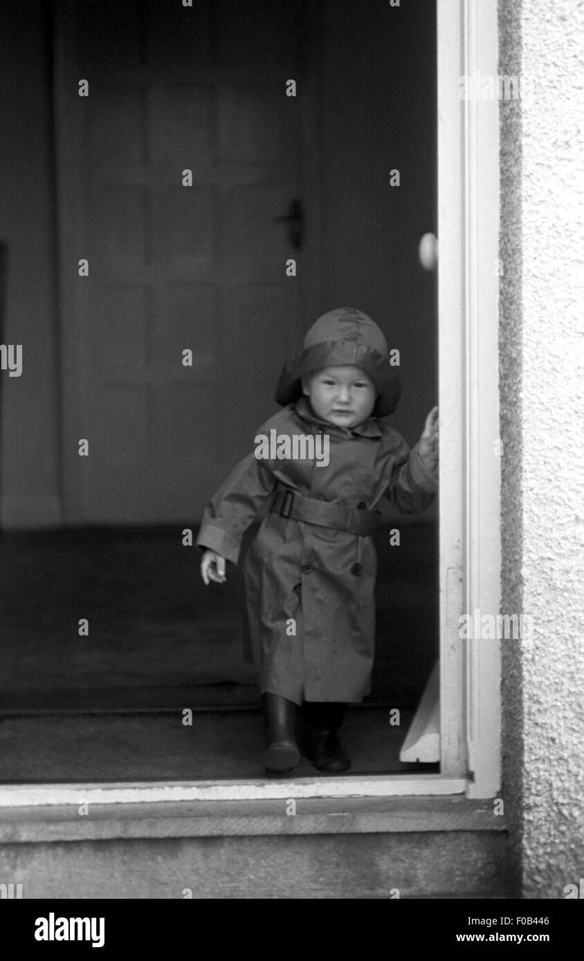 A young child in a doorway. Stock Photo