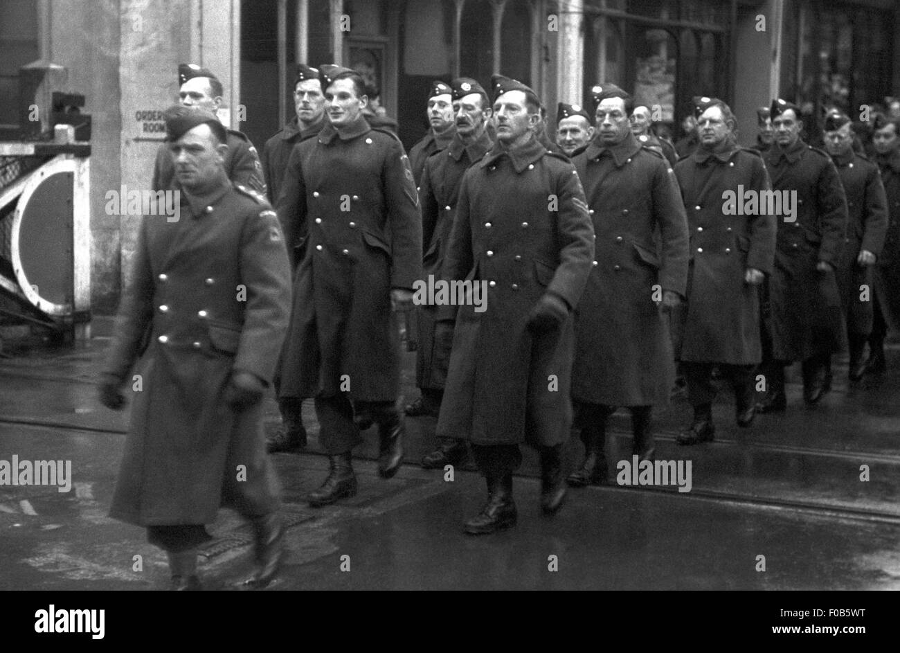 Men of the Home Guard in uniform marching down a street in England Stock Photo