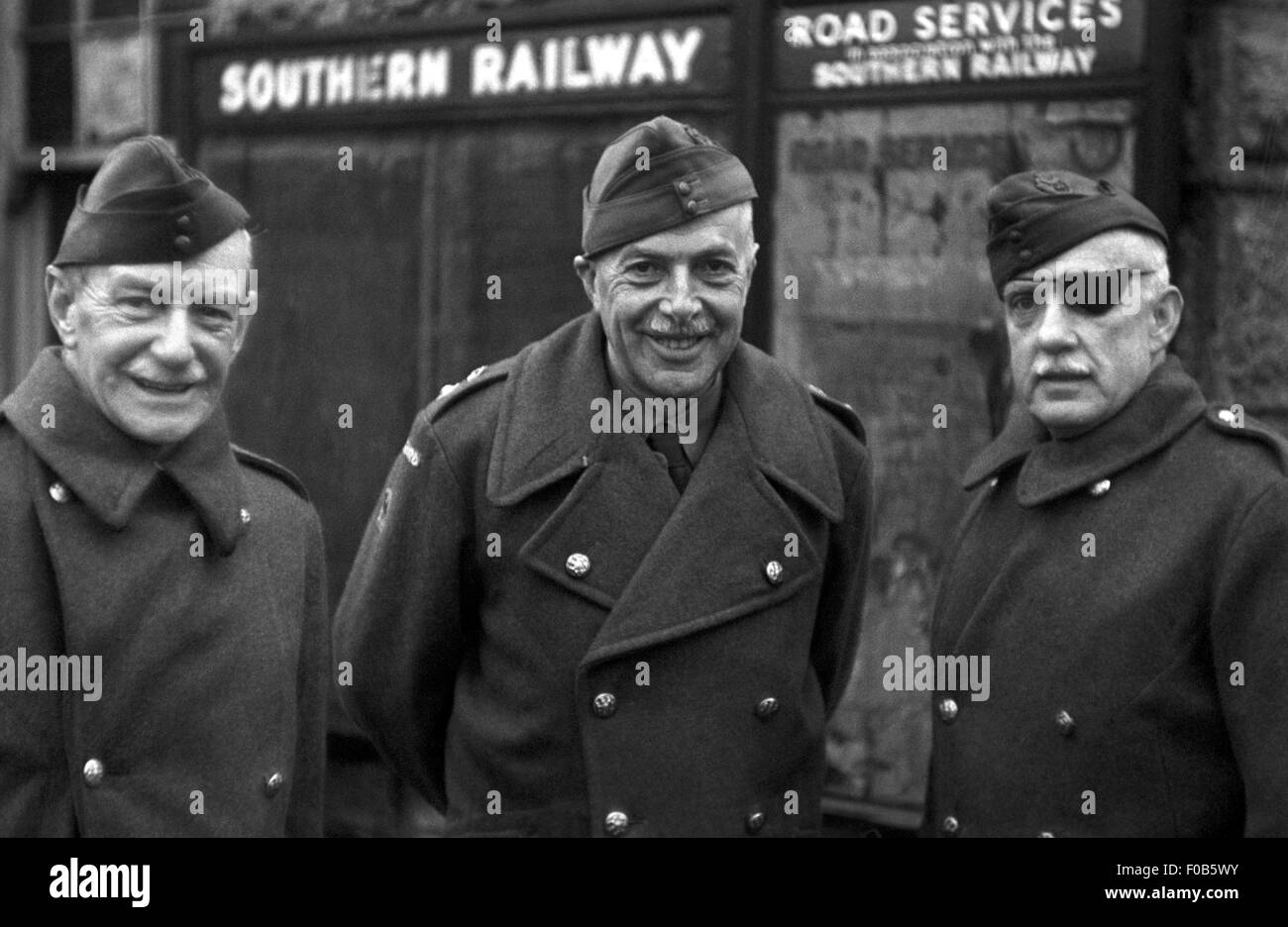 Three men of the Home Guard in uniform marching posing for a portrait Stock Photo