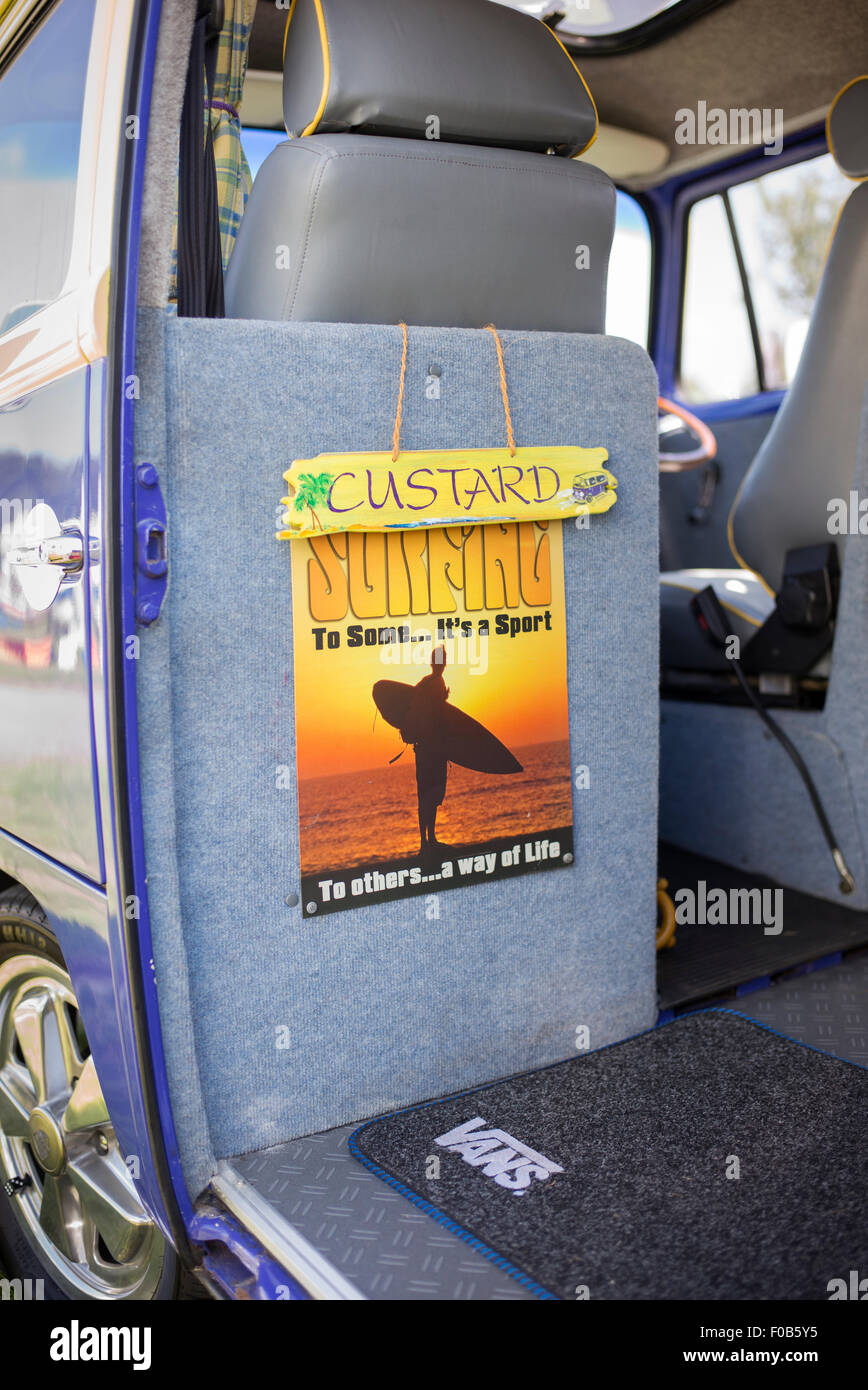 Surfing poster in the back of a Volkswagen camper van at a vintage retro show.  England Stock Photo